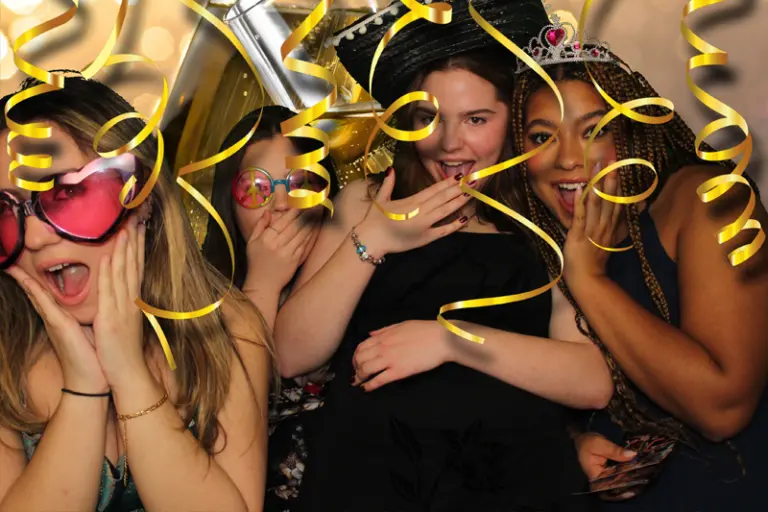 Group of women with tiaras and golden streamer effects by MagicPix